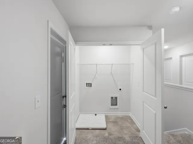 a view of a hallway with closet and wooden floor