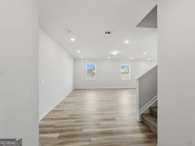 a view of hallway with wooden floor