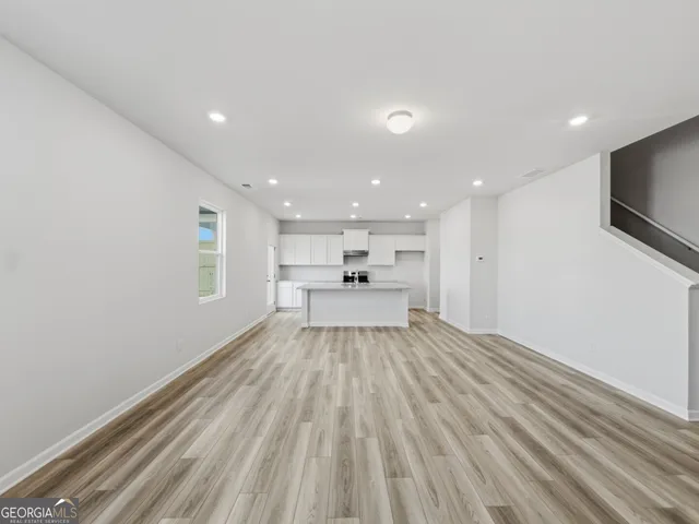 a view of kitchen with kitchen island sink and refrigerator
