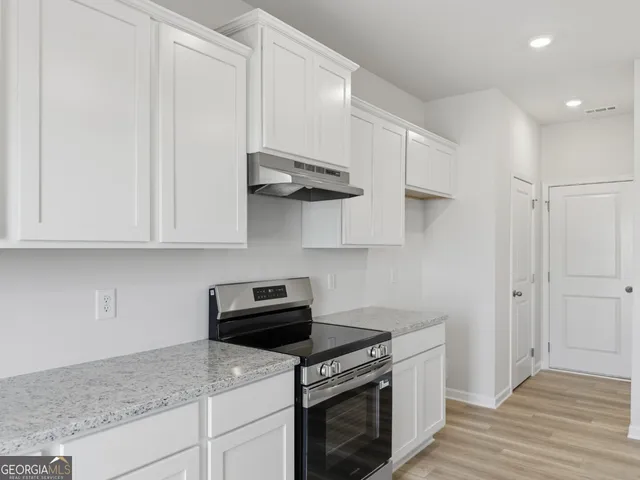 a kitchen with stainless steel appliances granite countertop a sink and cabinets