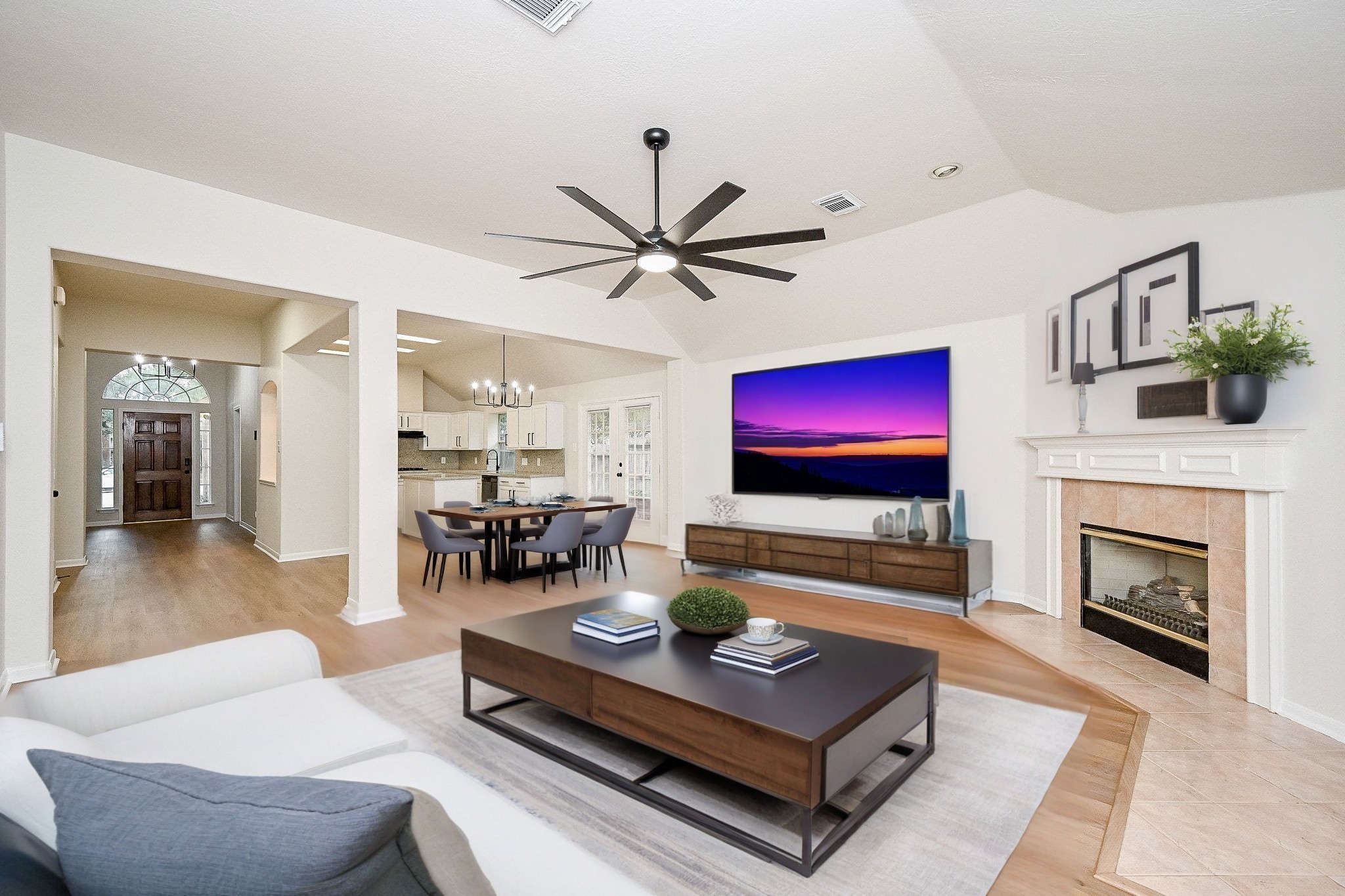 a living room with furniture a flat screen tv and a fireplace