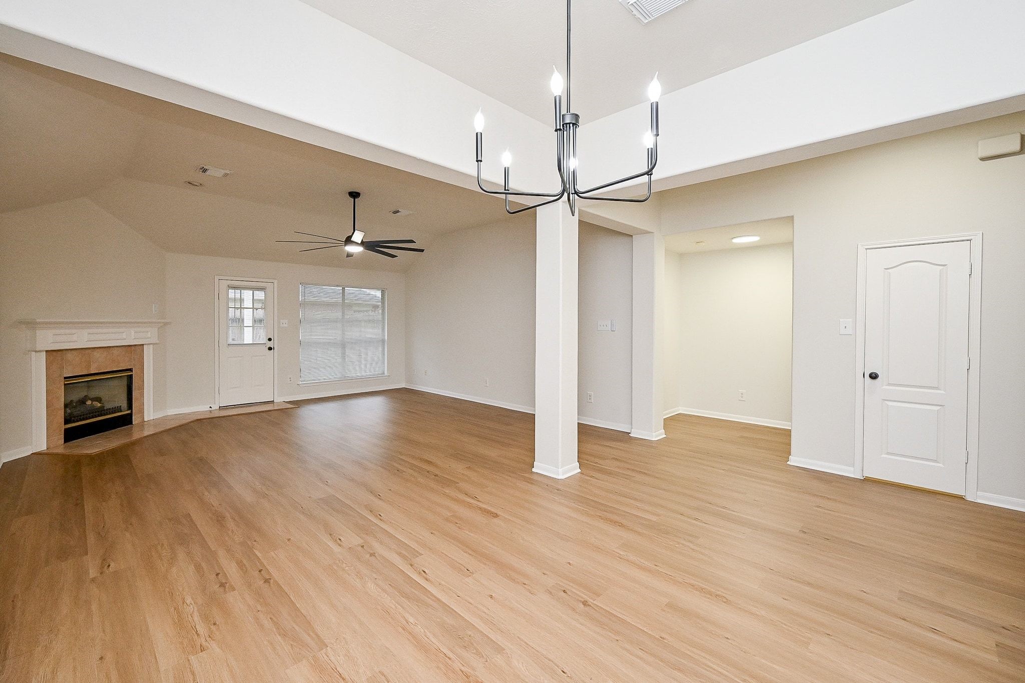 13007 Turnbridge Trail Houston, TX 77065 - Photo 12 of 20 a view of an empty room with wooden floor fireplace and a window