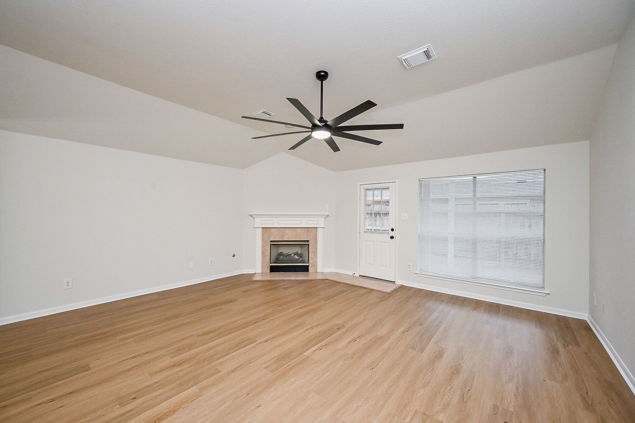 13007 Turnbridge Trail Houston, TX 77065 - Photo 13 of 20 wooden floor in an empty room with a window