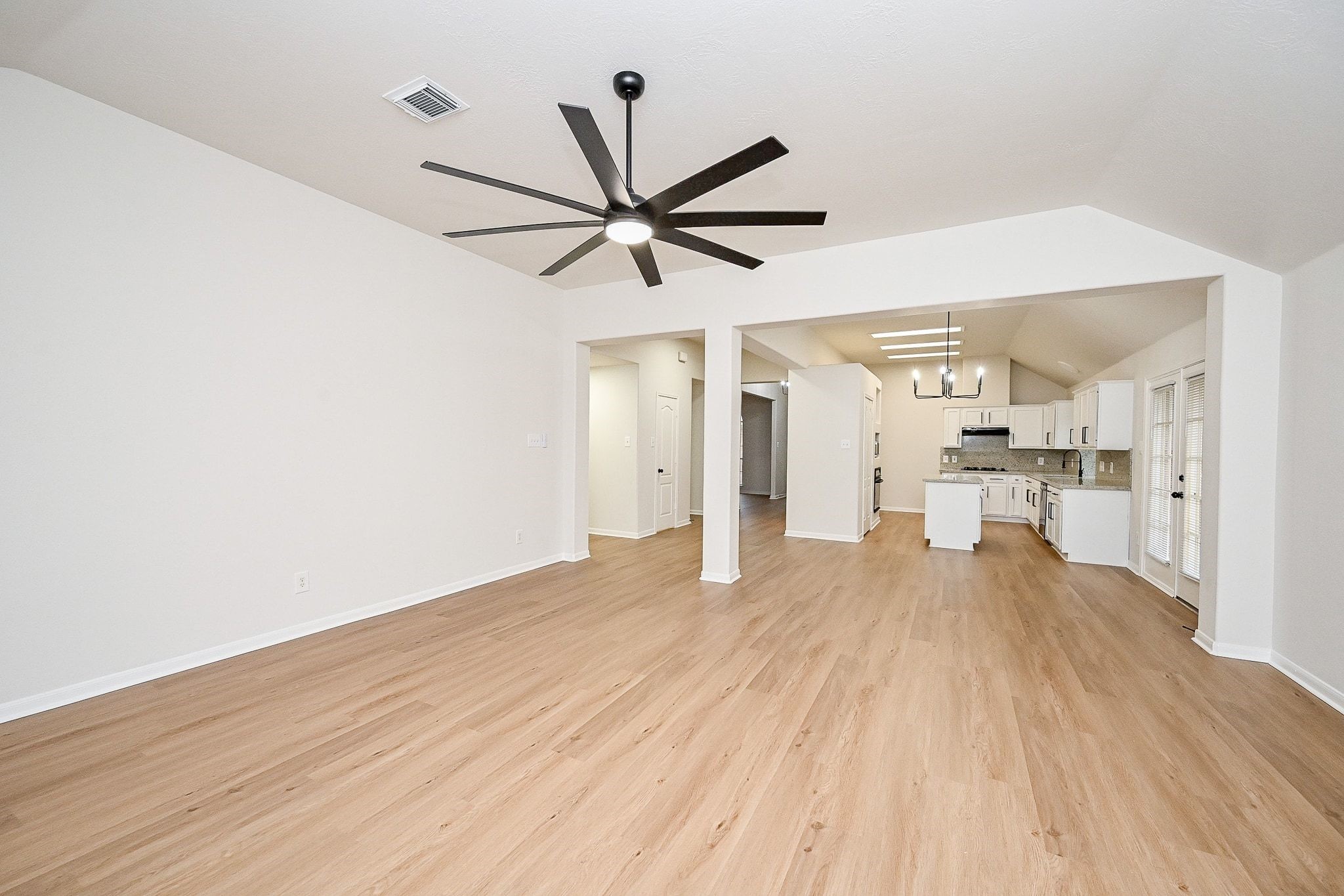 13007 Turnbridge Trail Houston, TX 77065 - Photo 14 of 20 a view of a livingroom with a hardwood floor and a ceiling fan