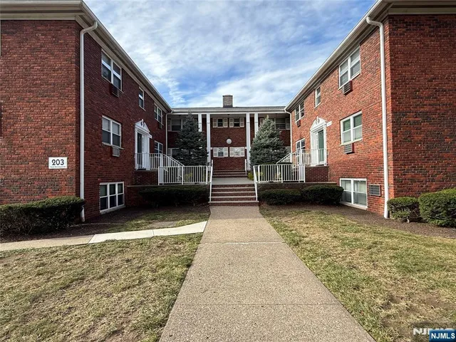 a view of a brick house with many windows