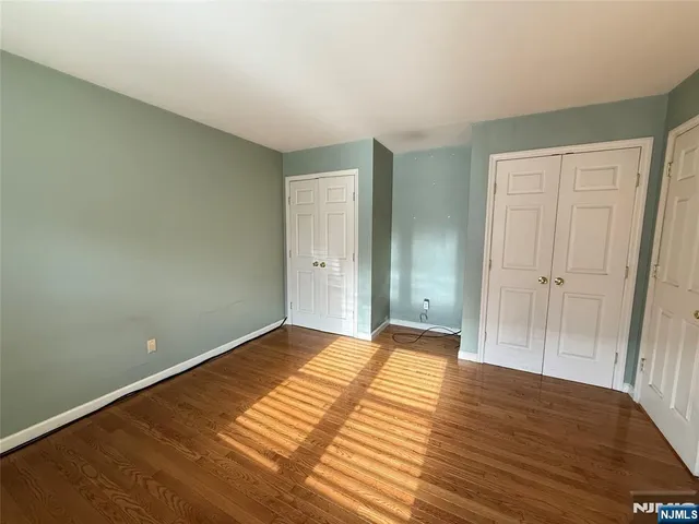 a view of a room with wooden floor and bathroom