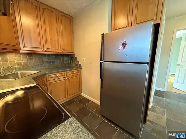 a white refrigerator freezer sitting in a kitchen