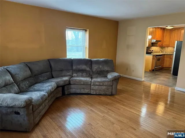 a living room with furniture and a kitchen