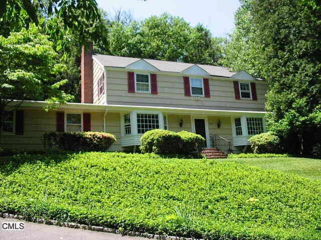 91 Wolfpit Road Wilton, CT 06897 - Photo 1 of 1 a front view of a house with a yard and outdoor seating