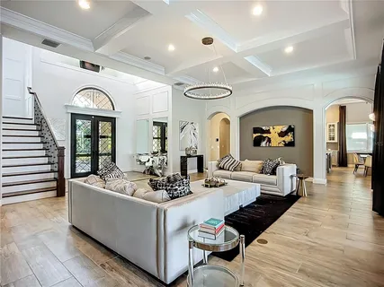 a living room with fireplace furniture and a rug