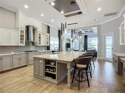 a large kitchen with a table and chairs in it
