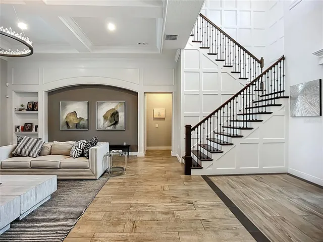 a living room with furniture table and a large window