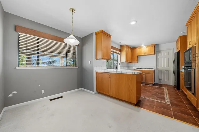 a view of staircase with white walls and windows