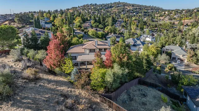 a kitchen with stainless steel appliances granite countertop a sink a refrigerator and a wooden floor