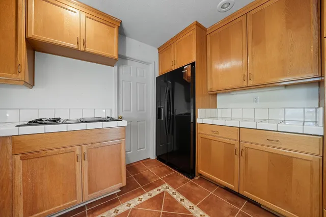 an aerial view of house with outdoor space and trees all around