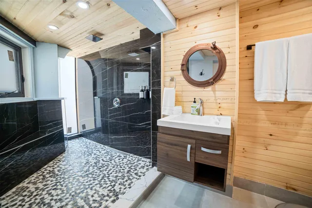 a bathroom with a sink a toilet and shower