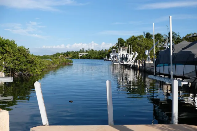a front view of a house with a yard outdoor seating and barbeque oven