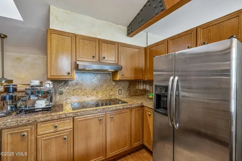 a kitchen with a refrigerator sink and cabinets