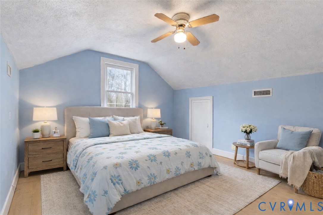 11221 Hanover Courthouse Road Hanover, VA 23069 - Photo 17 of 31 a bedroom with a bed and a chandelier