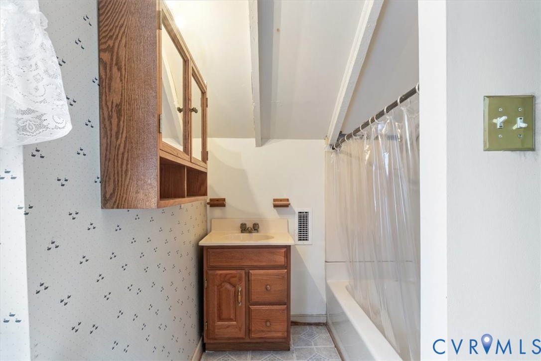 11221 Hanover Courthouse Road Hanover, VA 23069 - Photo 23 of 31 a bathroom with a sink a mirror and a shower