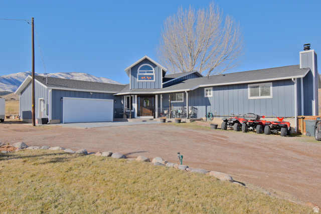 656 South Bullion Canyon Road Marysvale, UT 84750 - Photo 32 of 57 View of front of home with covered porch, a chimney, driveway, a garage, and roof with shingles