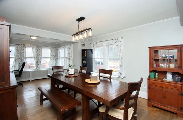 a view of a dining room with furniture window and wooden floor