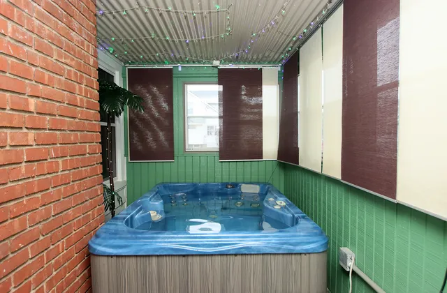 a view of outdoor kitchen with sink and window