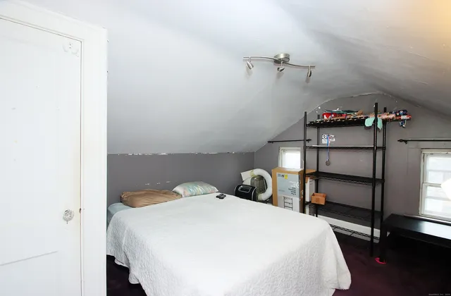 a bedroom with a bed and a window