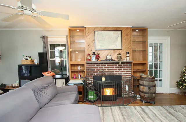 a living room with furniture a fireplace and a table