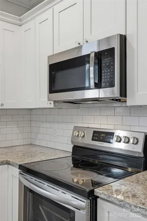 a kitchen with appliances a sink and cabinets