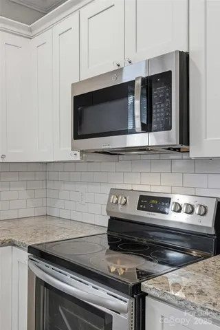 a kitchen with appliances a sink and cabinets