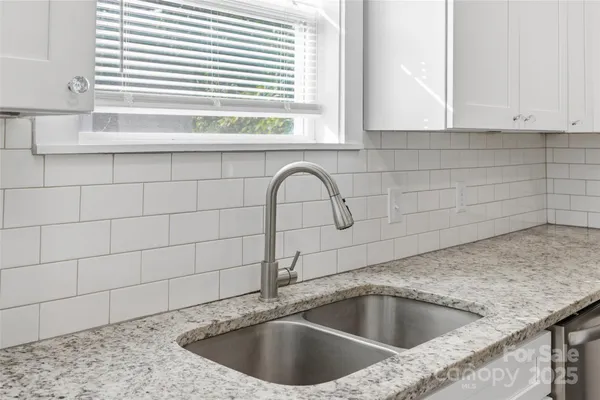 a view with a sink and granite floor