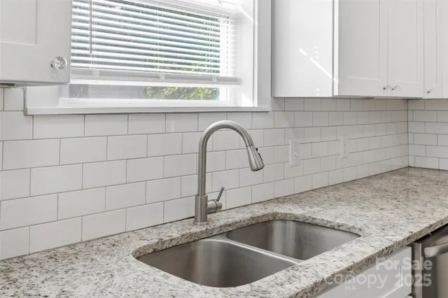 a view with a sink and granite floor