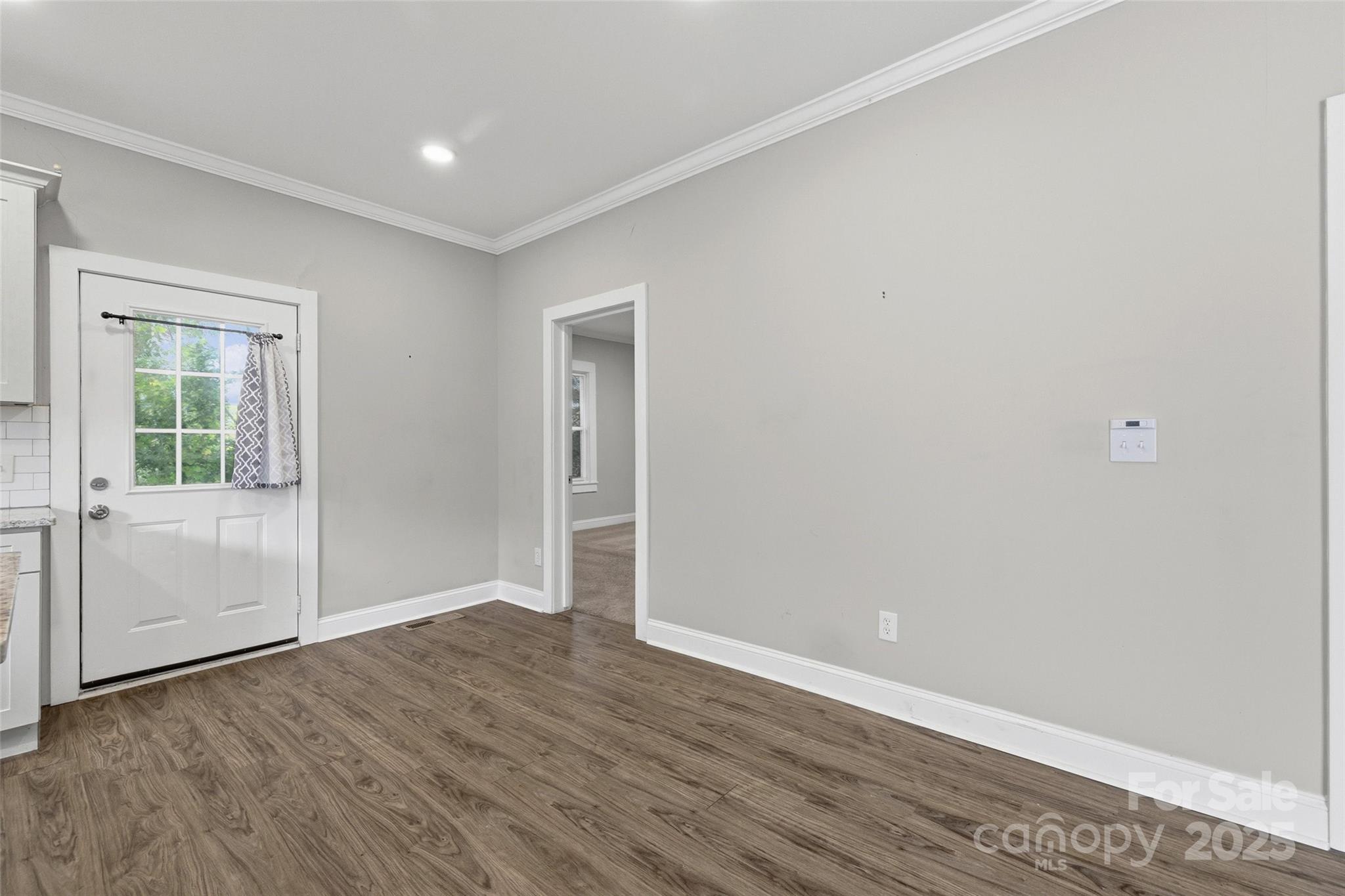 1257 Springdale Road Lancaster, SC 29720 - Photo 14 of 29 an empty room with wooden floor & windows