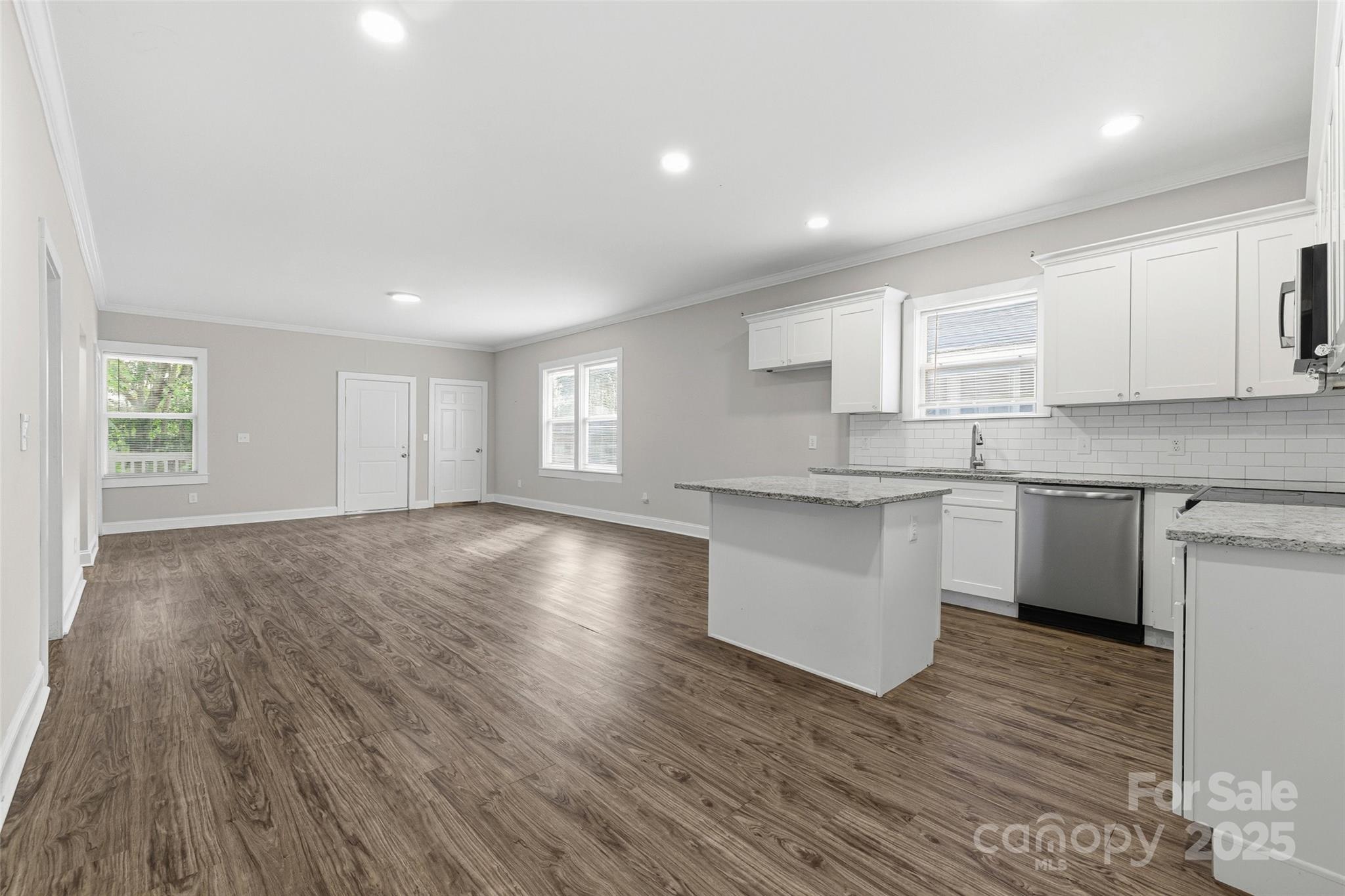 1257 Springdale Road Lancaster, SC 29720 - Photo 15 of 29 a kitchen with granite countertop a sink cabinets and wooden floor