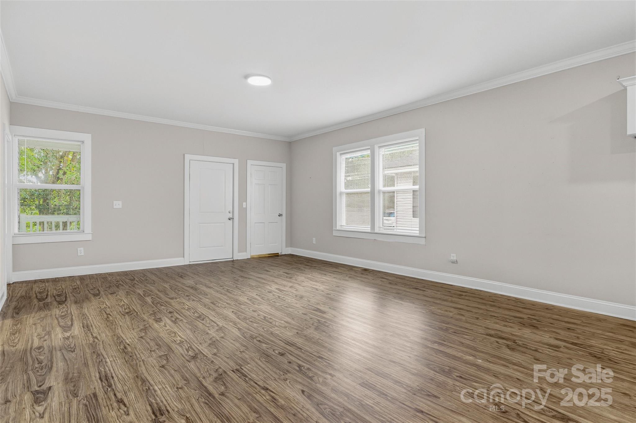 1257 Springdale Road Lancaster, SC 29720 - Photo 4 of 29 an empty room with wooden floor and windows