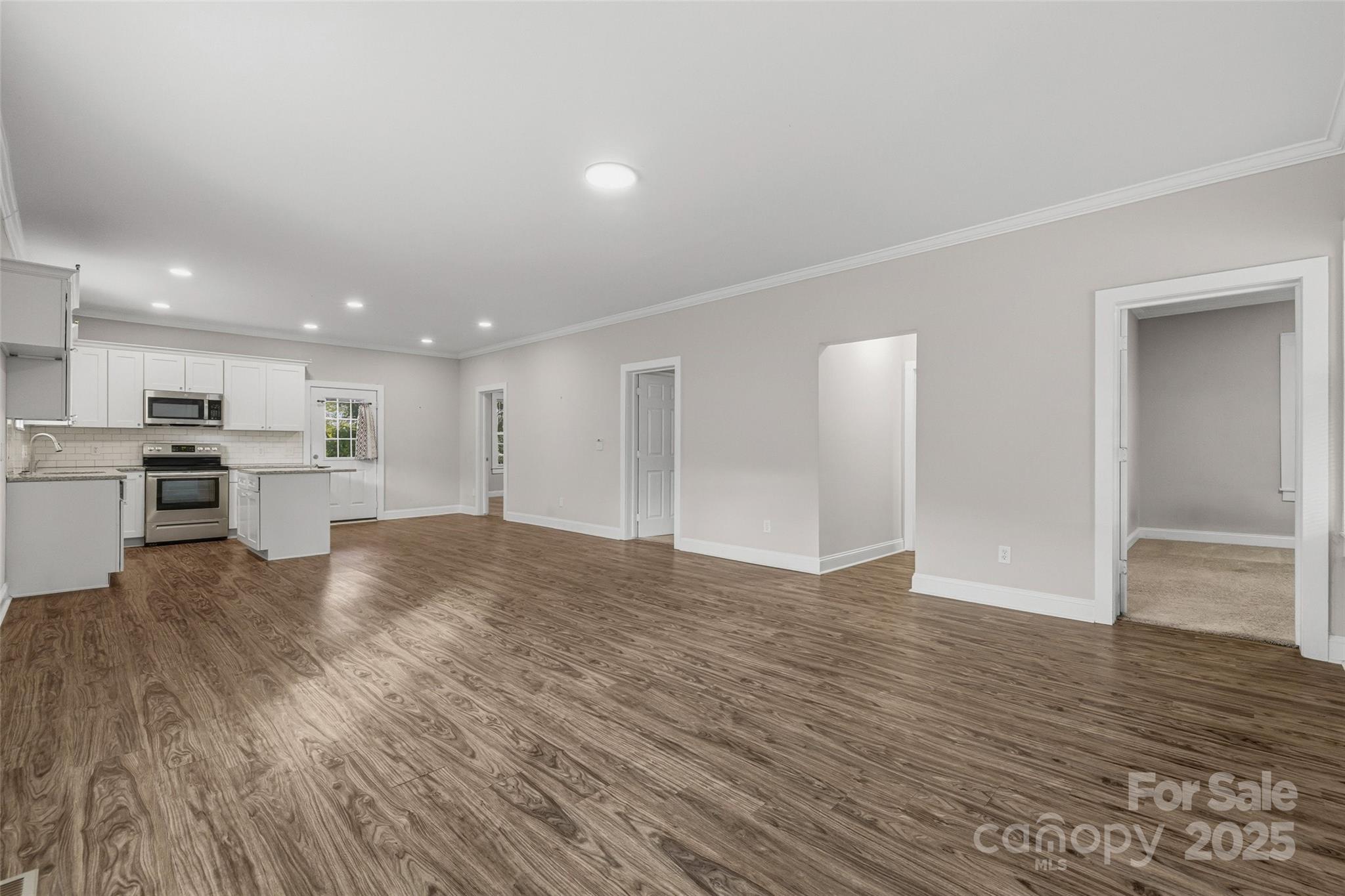 1257 Springdale Road Lancaster, SC 29720 - Photo 6 of 29 a view of kitchen with kitchen island wooden floor appliances and cabinets