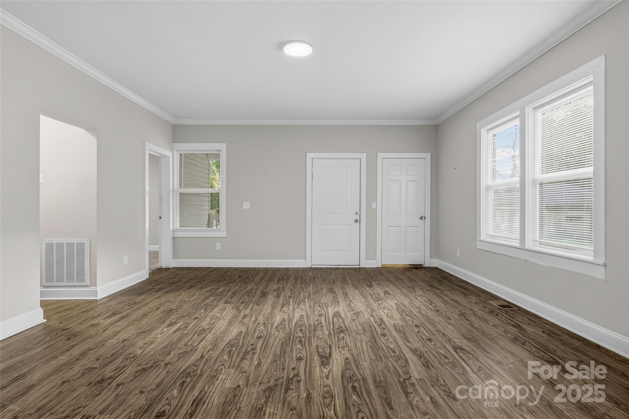 1257 Springdale Road Lancaster, SC 29720 - Photo 7 of 29 a view of an empty room with wooden floor and a window