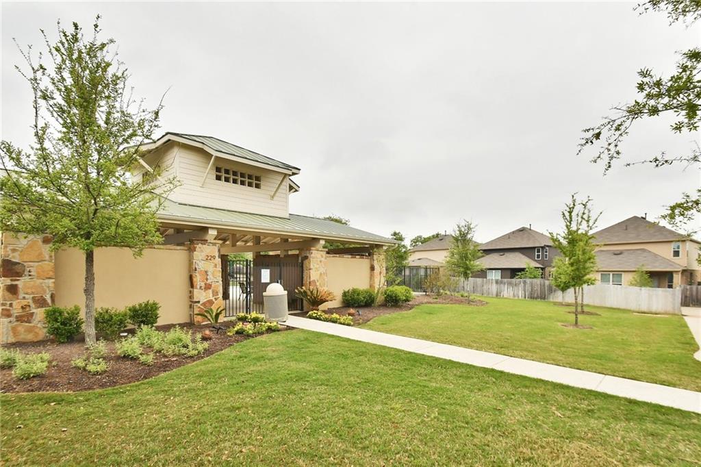 3451 Mayfield Ranch Boulevard, Unit 340 Round Rock, TX 78681 - Photo 11 of 13 A well-kept lawn and a charming stone and stucco community building welcome residents to a peaceful neighborhood.