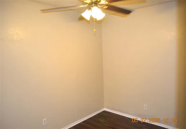 a view of a small space with wooden floor and a window