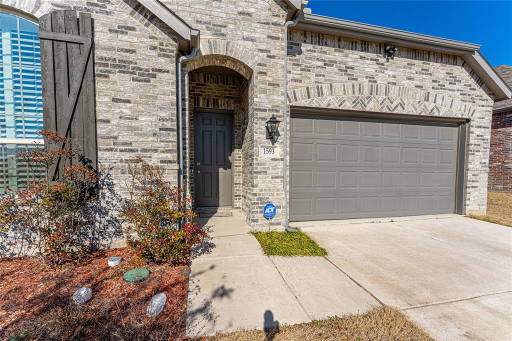 1593 Kessler Drive Forney, TX 75126 - Photo 1 of 1 a front view of a house with a garage