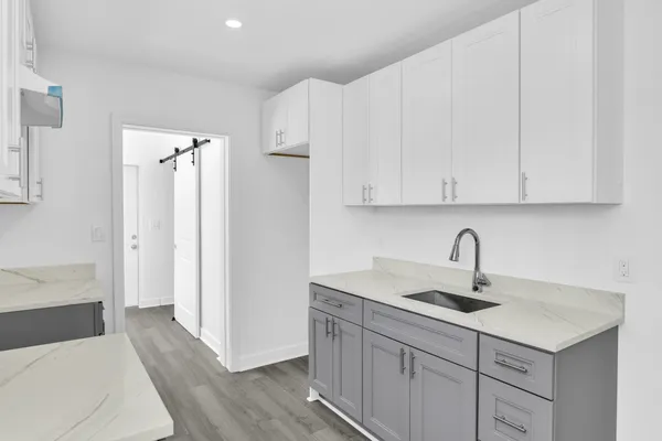 a kitchen with stainless steel appliances a sink and cabinets