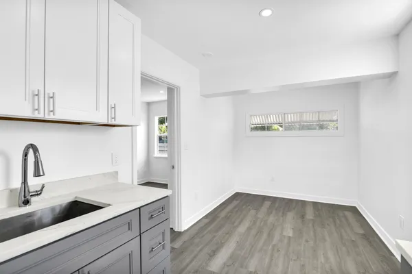 a view of a kitchen with sink and cabinets