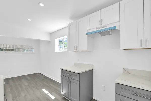 a kitchen with cabinets and a wooden floor