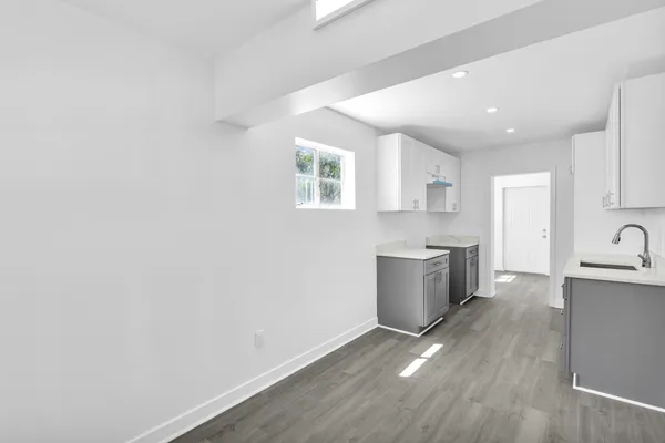 a kitchen with a refrigerator and a sink