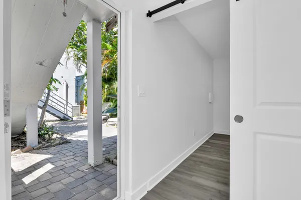 a view of entryway with wooden floor and door