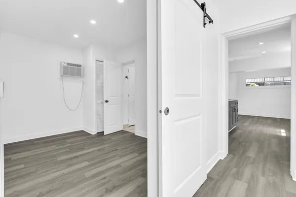 a view of hallway with wooden floor