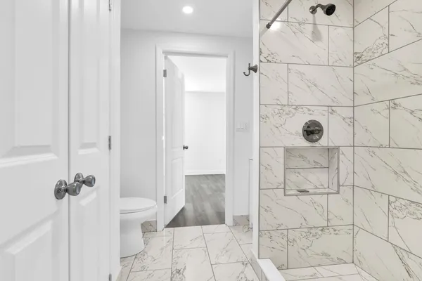 a bathroom with a glass shower door