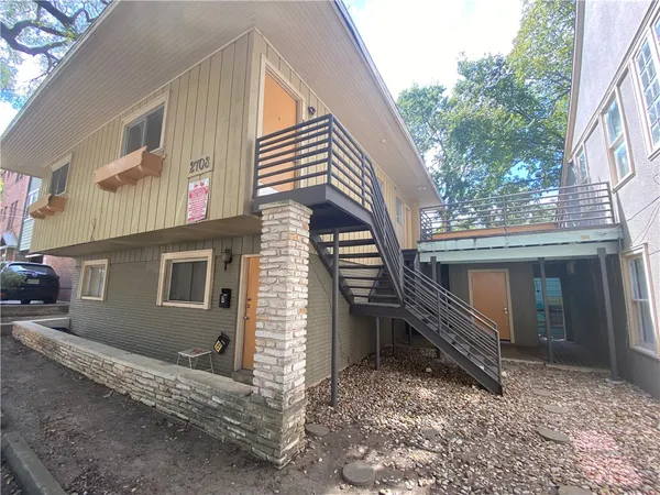 a view of house with a door and wooden fence