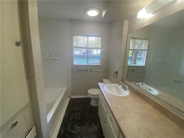 a bathroom with a sink a toilet and tub